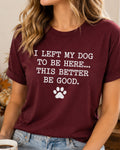 A woman wearing a maroon short-sleeve graphic t-shirt with the white printed text 'I LEFT MY DOG TO BE HERE.