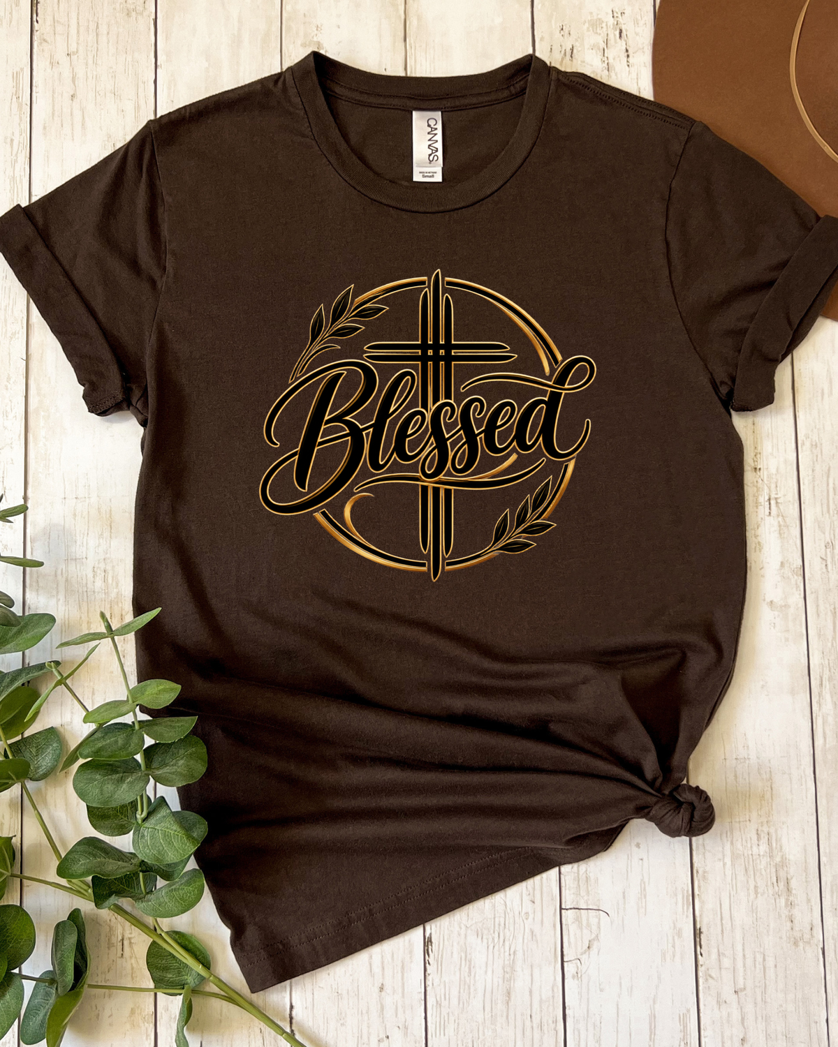 Flatlay of a Blessed cross Christian brown graphic tee
